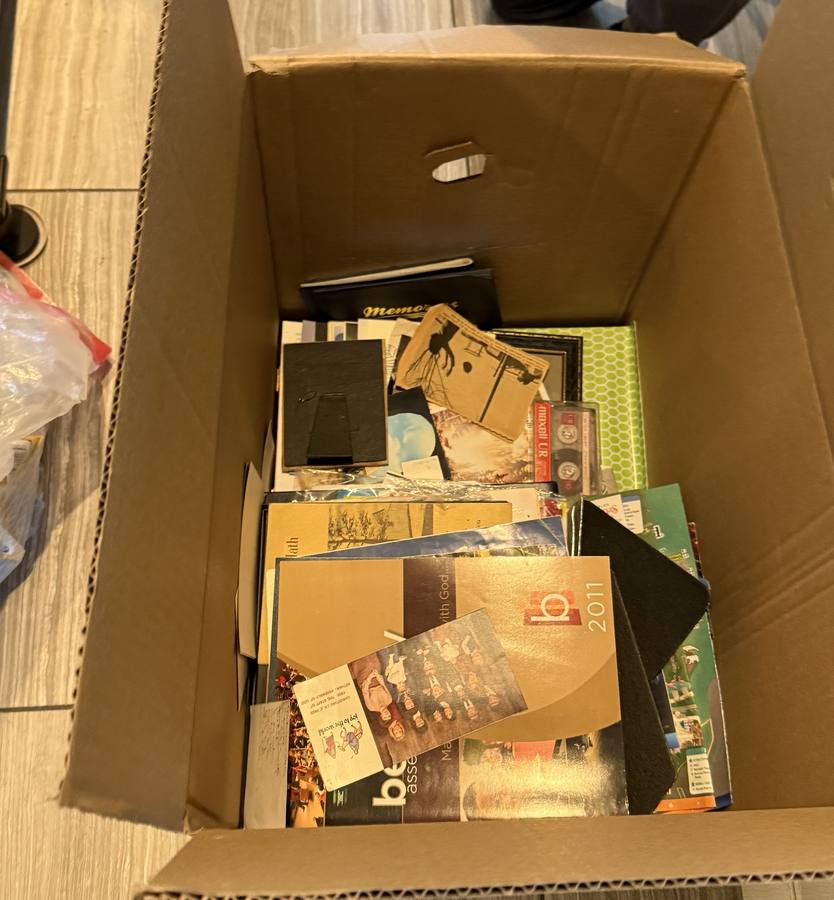 Box of family photographs and keepsakes set aside for care