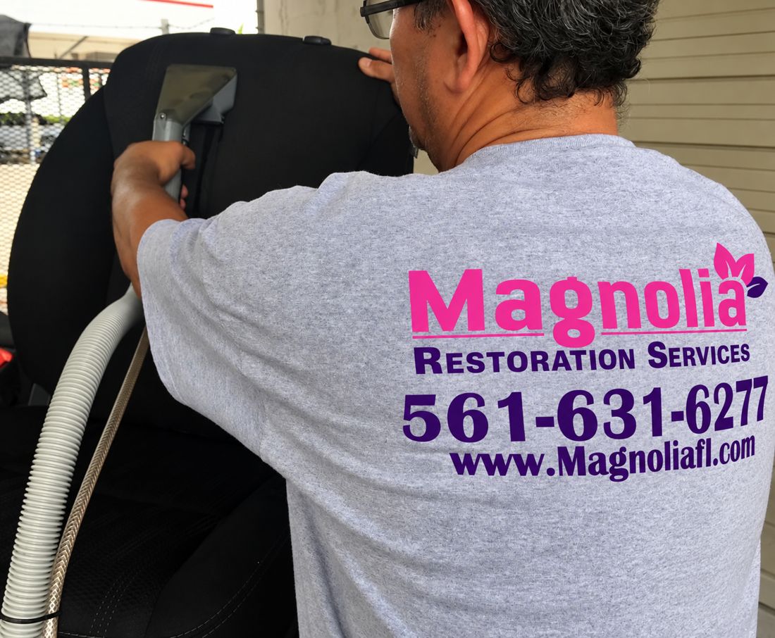 Magnolia technician extraction-cleaning an upholstered seat