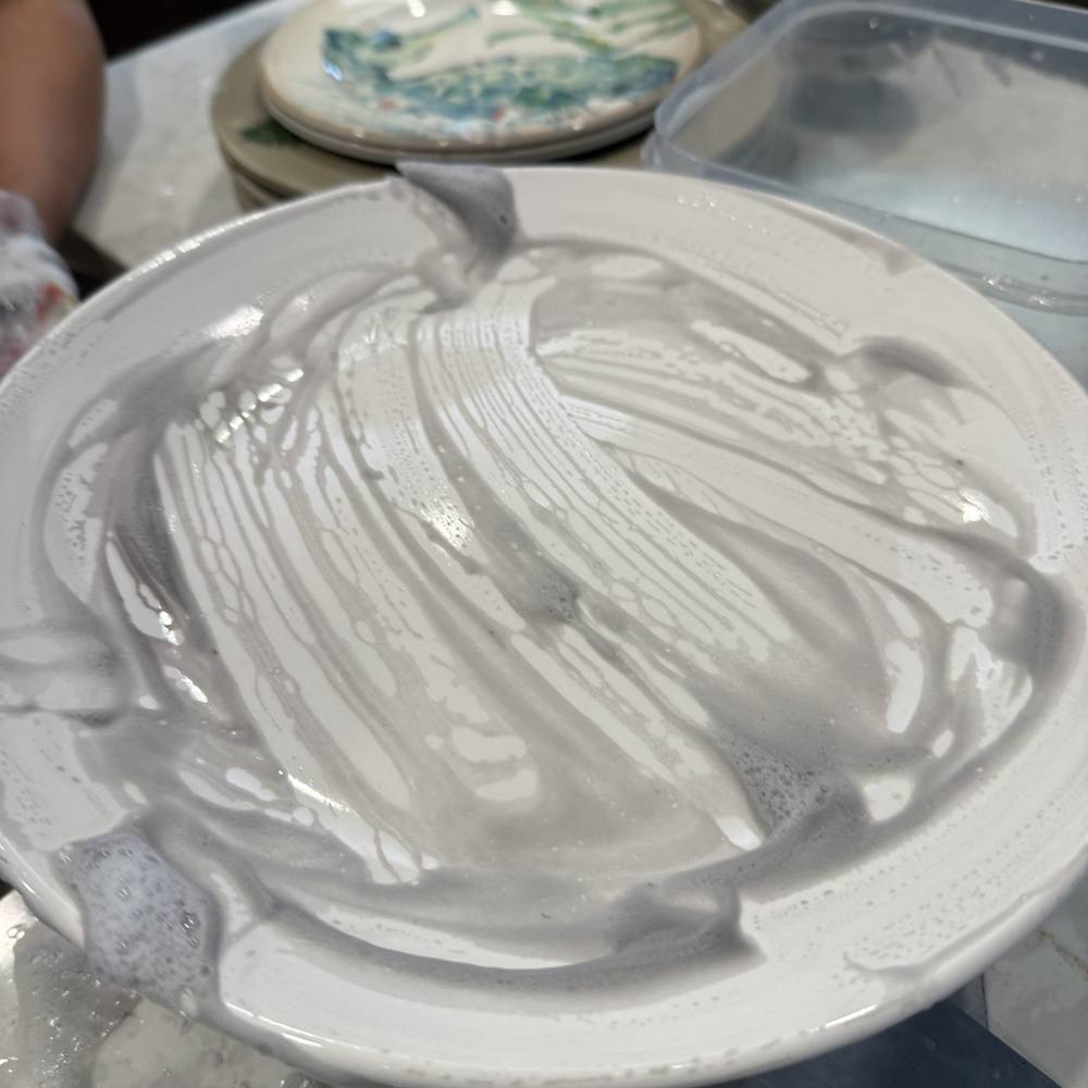 Plate being washed of residue