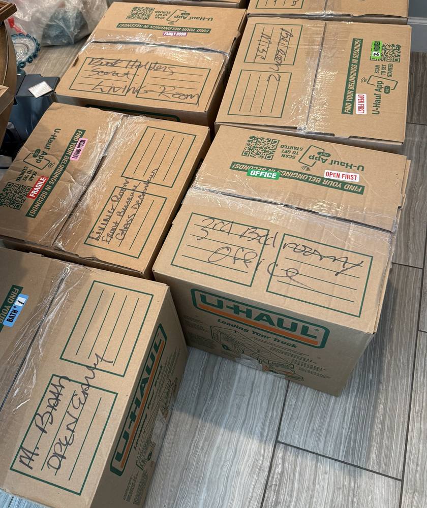 Boxes labeled by room and contents