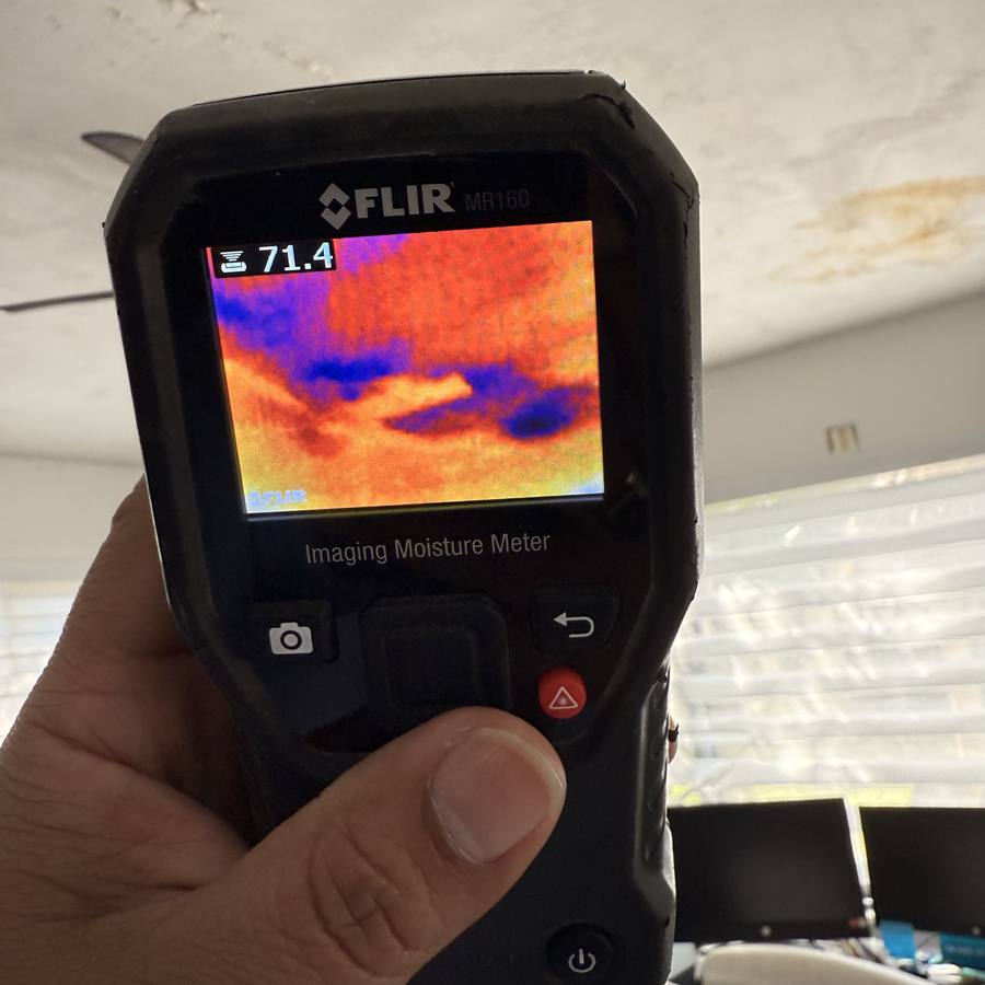 Thermal imaging moisture meter showing a wet area